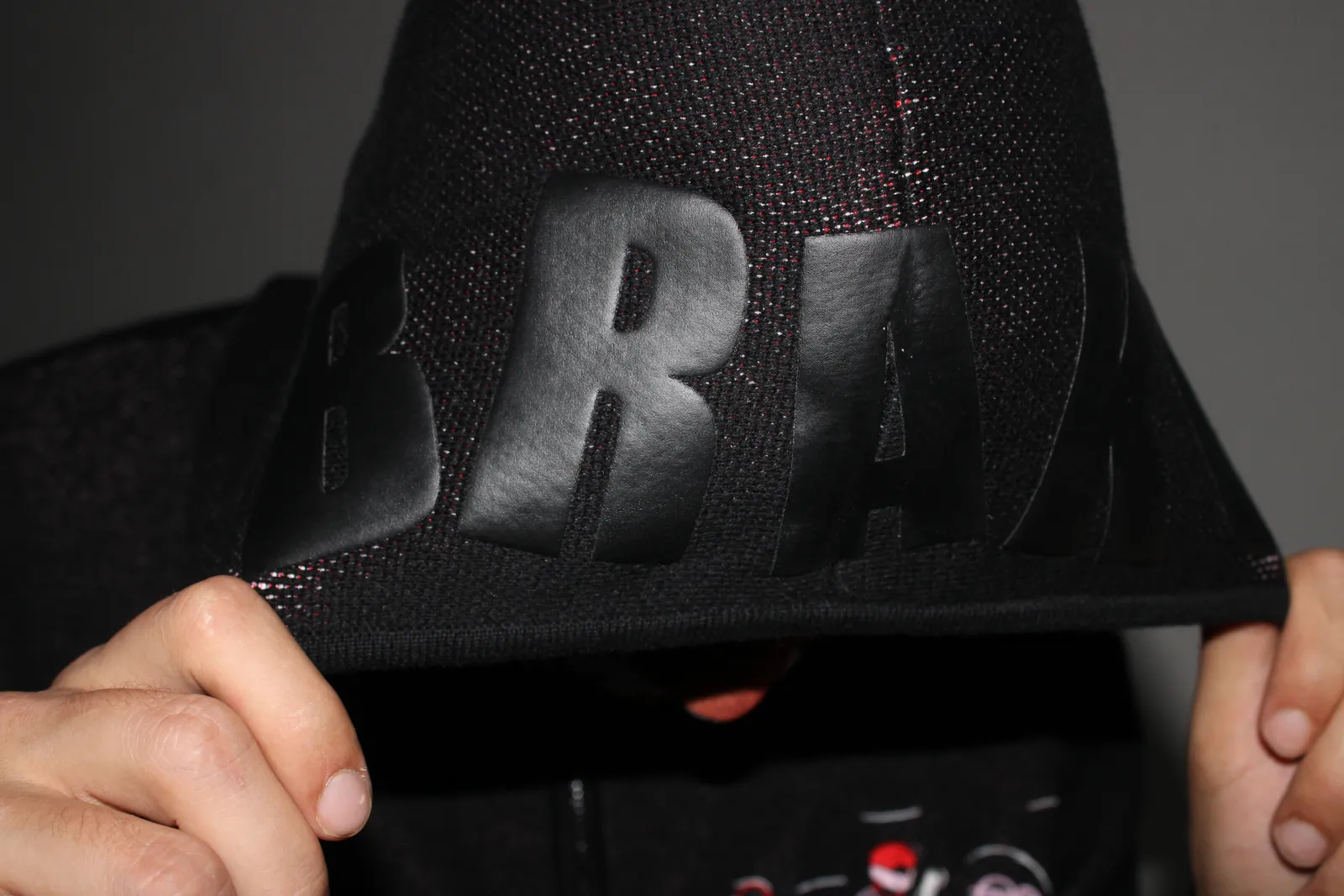 The embossed BRAKO hood, held up by hand